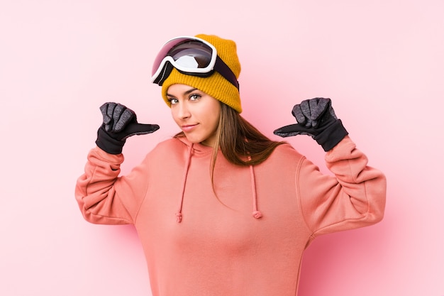 Young woman wearing a ski clothes feels proud and self confident, example to follow