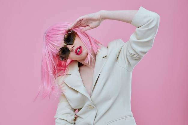 Young woman wearing sunglasses pink hair posing color background unaltered High quality photo