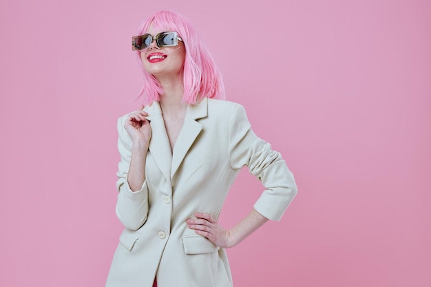 Young woman wearing sunglasses pink hair posing color background unaltered