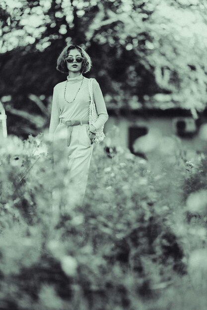 Photo young woman wearing sunglasses standing on land