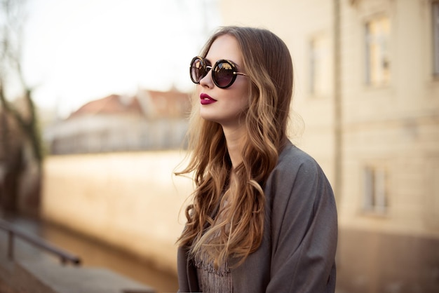 young woman wearing sunglasses standing outdoors