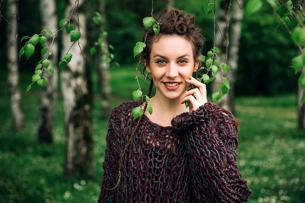 Young woman wearing sweater  and posing the park