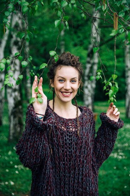 Young woman wearing sweater  and posing the park