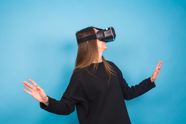 Young woman wearing virtual reality device. Technology, virtual reality and people concept.