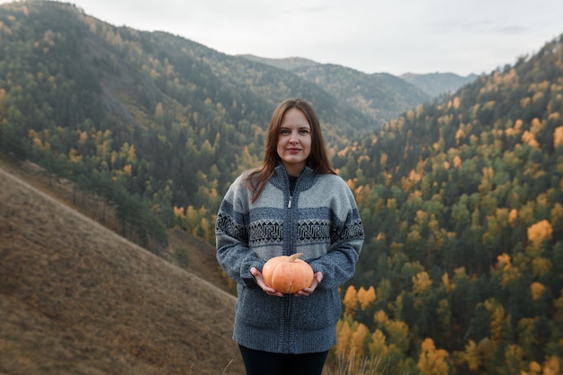 Young woman wearing a warm sweater in the mountains