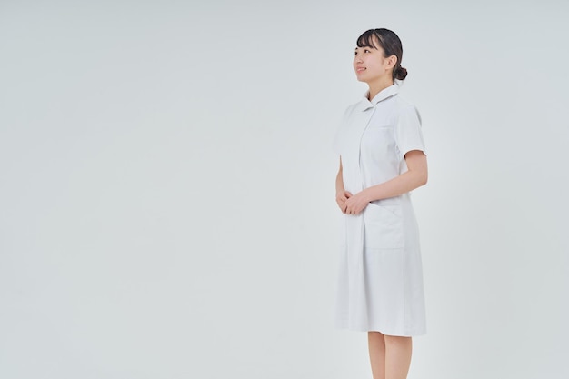 Young woman wearing a white coat indoors