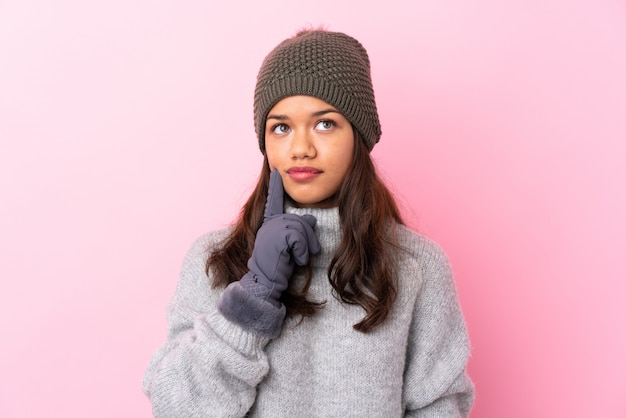 young woman wearing winter jacket over isolated wall