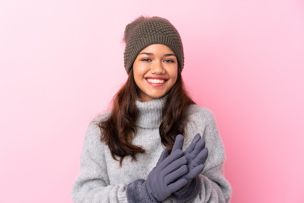 young woman wearing winter jacket over isolated wall