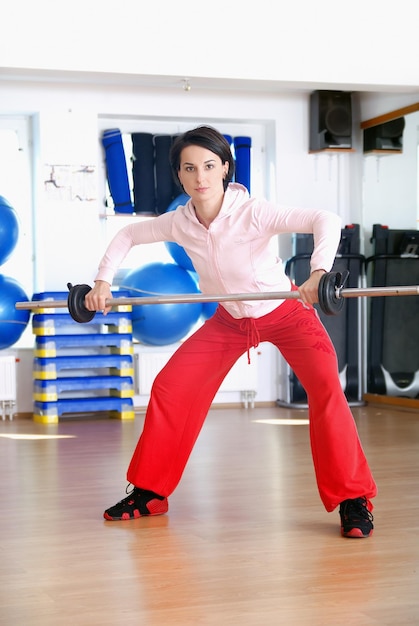 .a young woman weightlifting at gym