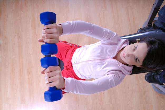 .a young woman weightlifting at gym