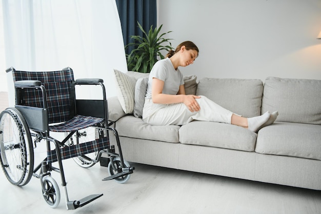 Young woman in wheelchair at home