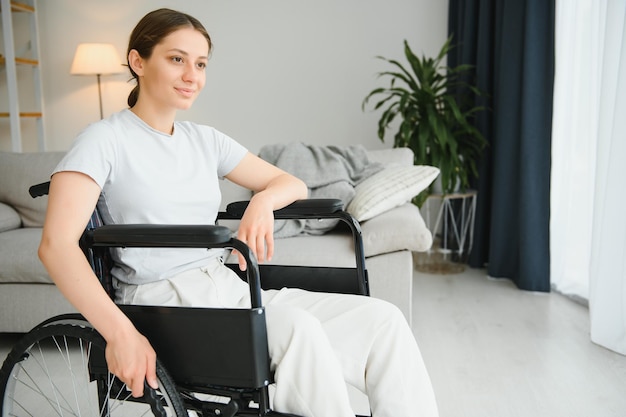 Young woman in wheelchair at home