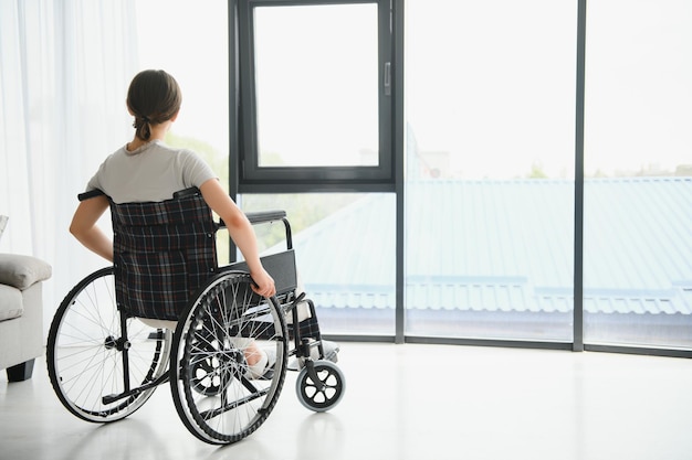 Young woman in wheelchair at home