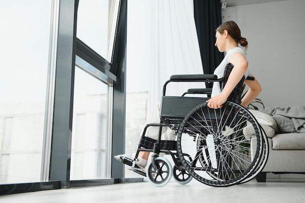 Young woman in wheelchair at home