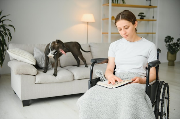 Young woman in wheelchair at home