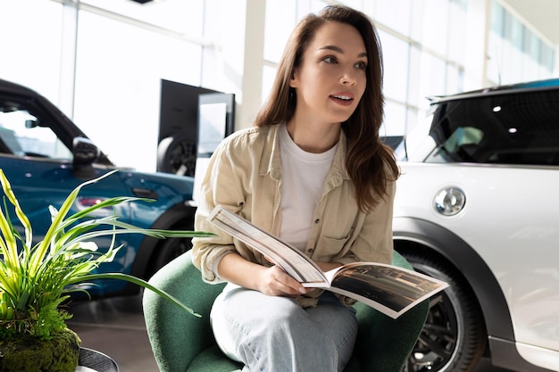 A young woman when buying a new car cannot choose a complete set