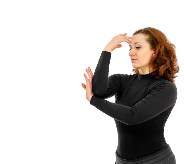 Young woman on a white background pulled back with her hand