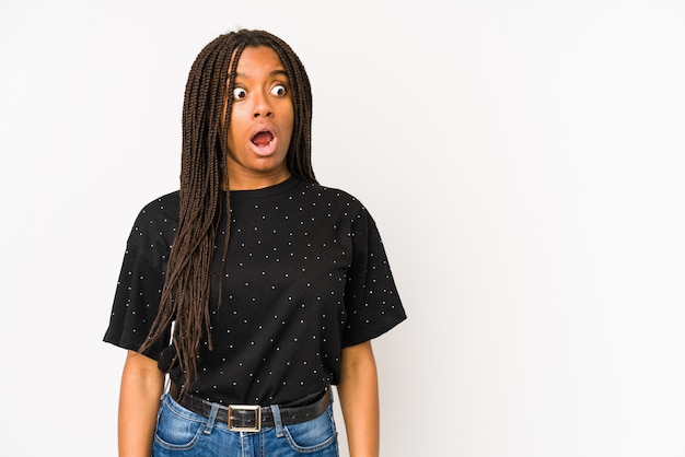 Young woman on white being shocked because of something she has seen.