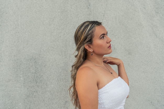 Young woman in white dress outdoors.