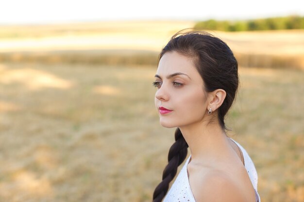 Young  woman in white dress in wheat field. girl in wheat field