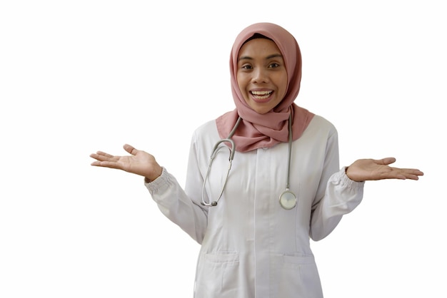 A young woman in a white robe with a stethoscope on her neck stands with her hands up and smiles.