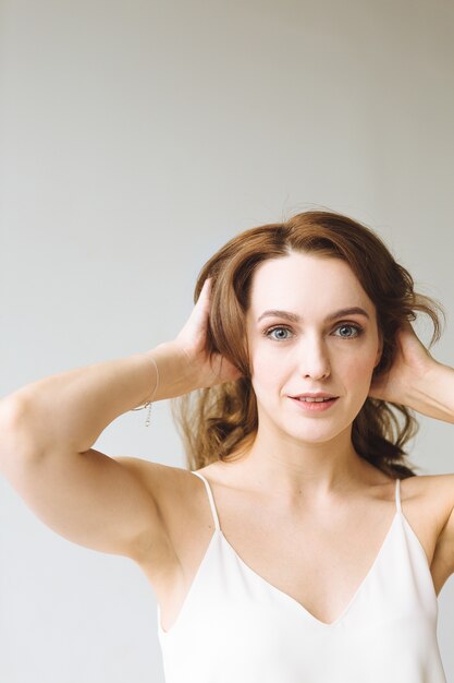 Young woman in white shirt on white background