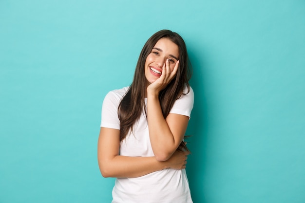 Young woman in white T-shirt posing