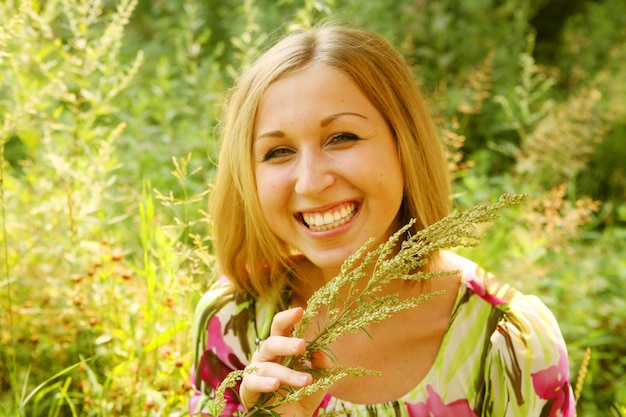 Young woman and wild flowers. 