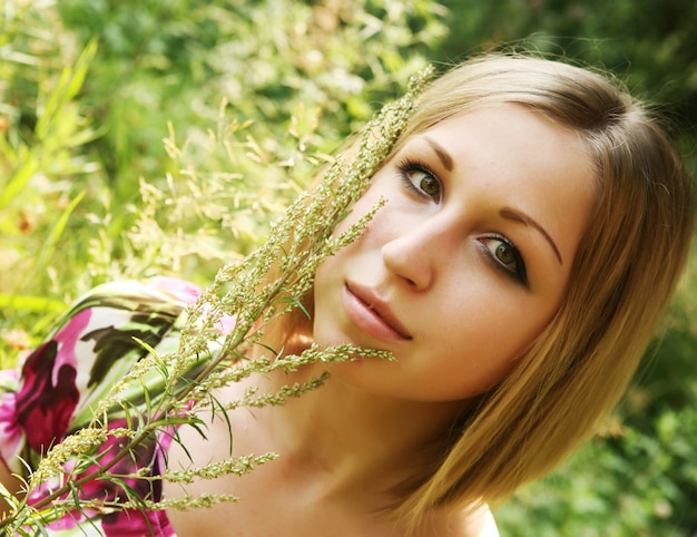 若い女性と野生の花。