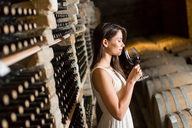 Young woman in the wine cellar