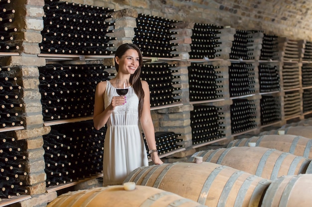 Young woman in the wine cellar