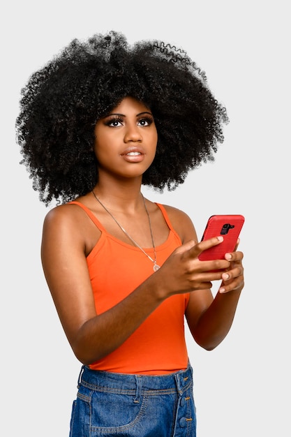 Young woman with afro hairstyle holding cell phone isolated on gray background person advertising c