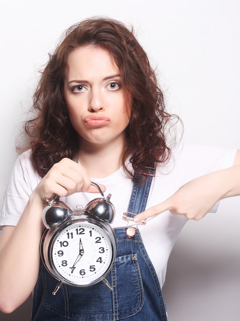 Young woman with alarmclock