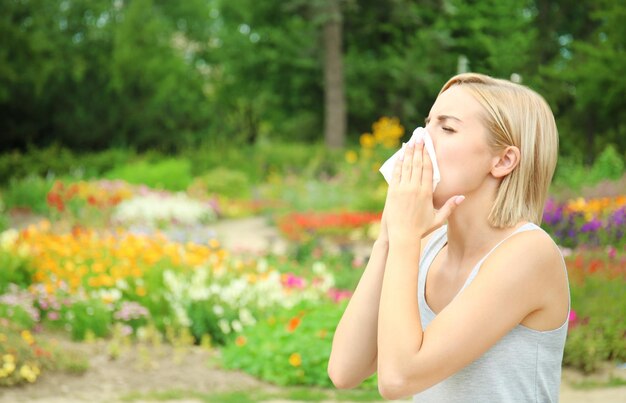 Young woman with allergy outdoors