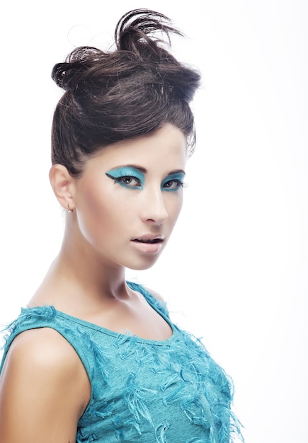 Young woman with amazing hairstyle in blue dress