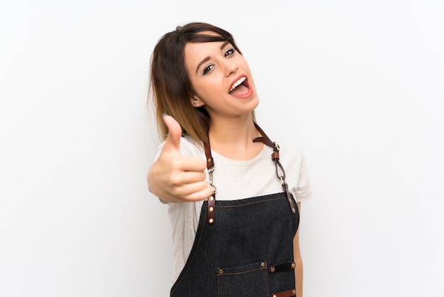 Young woman with an apron with thumbs up because something good has happened