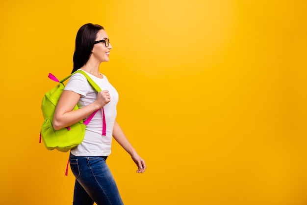 young woman with backpack and books