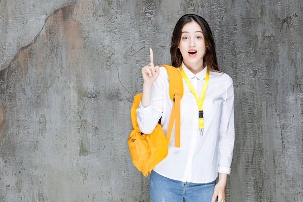 Young woman with backpack looking shocked. High quality photo