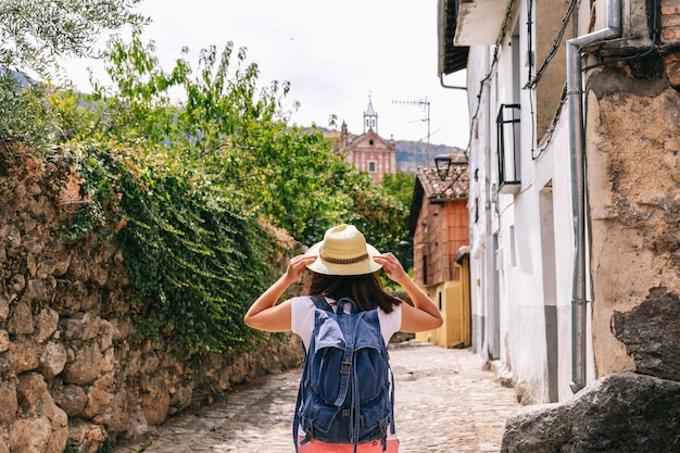 Young woman with a backpack on a trip