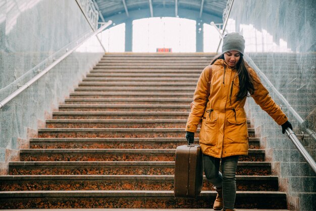 Young woman with bags on stairs