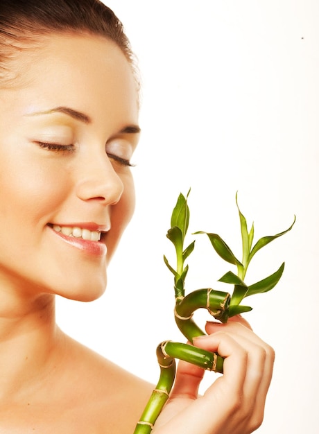 Young woman with a bamboo plant