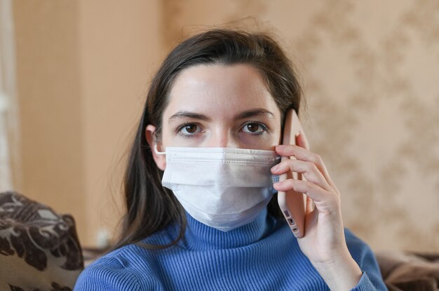 Young woman with a bandage and a phone near her ear