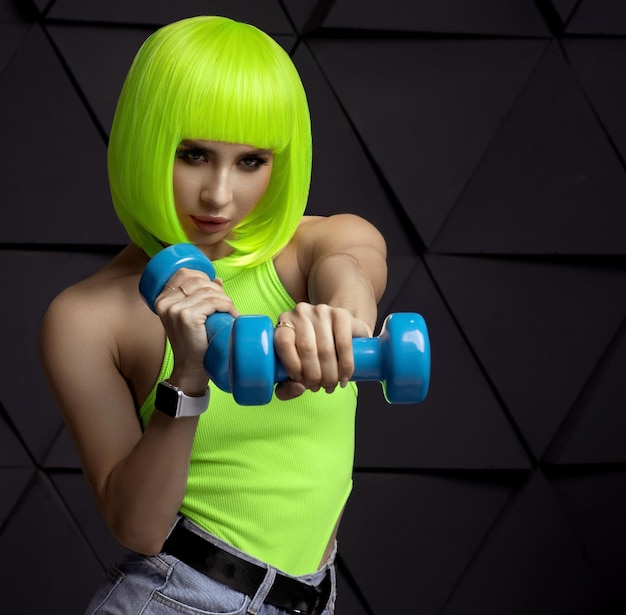 Young woman with beautiful slim healthy body posing in studio Fitness female model in sportswear on grey background