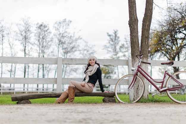 Young woman with bicycle in a park