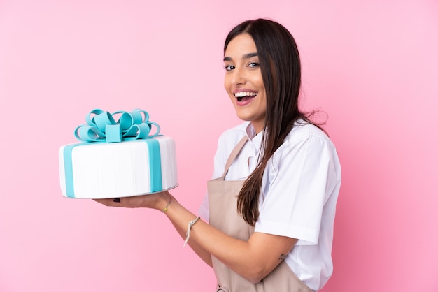 Young woman with a big cake