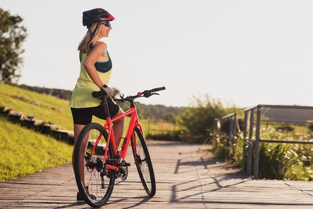 Young woman with bike outdoors at the park