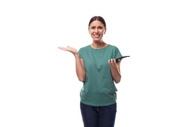 A young woman with black hair and a slim figure dressed in a green tshirt has doubts holding a