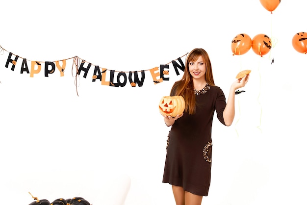 young woman with black pumkin in Halloween decoration