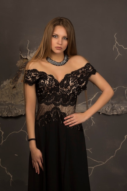 Young woman with blonde hair dressed in lace dress.Studio shot