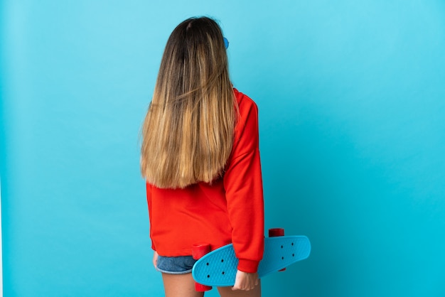 Young woman with a blue skateboard